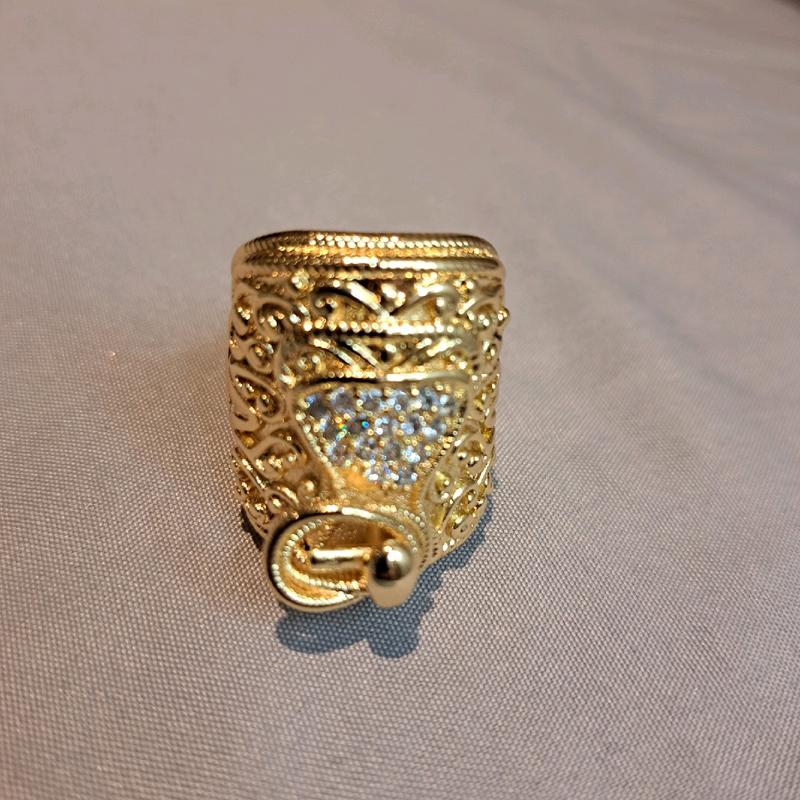 large saddle ring adjustable for size. gold plated stainless Steel. 4