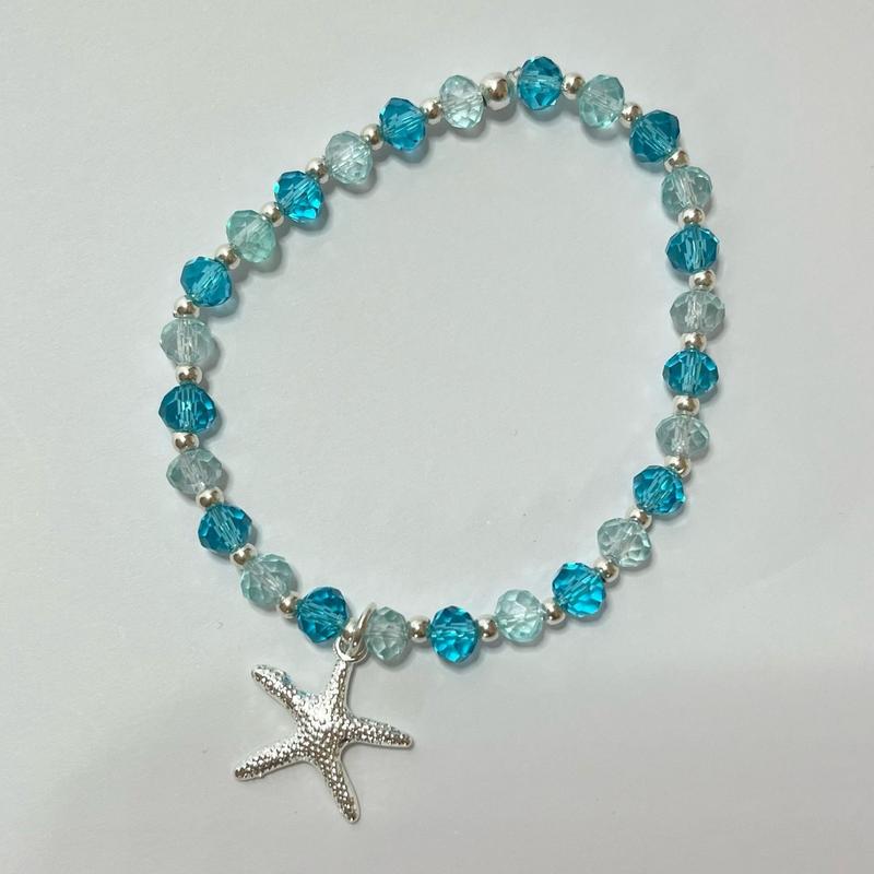Blue glass bead stretchy bracelet with starfish charm approx. 7” but can be made to any size. 0