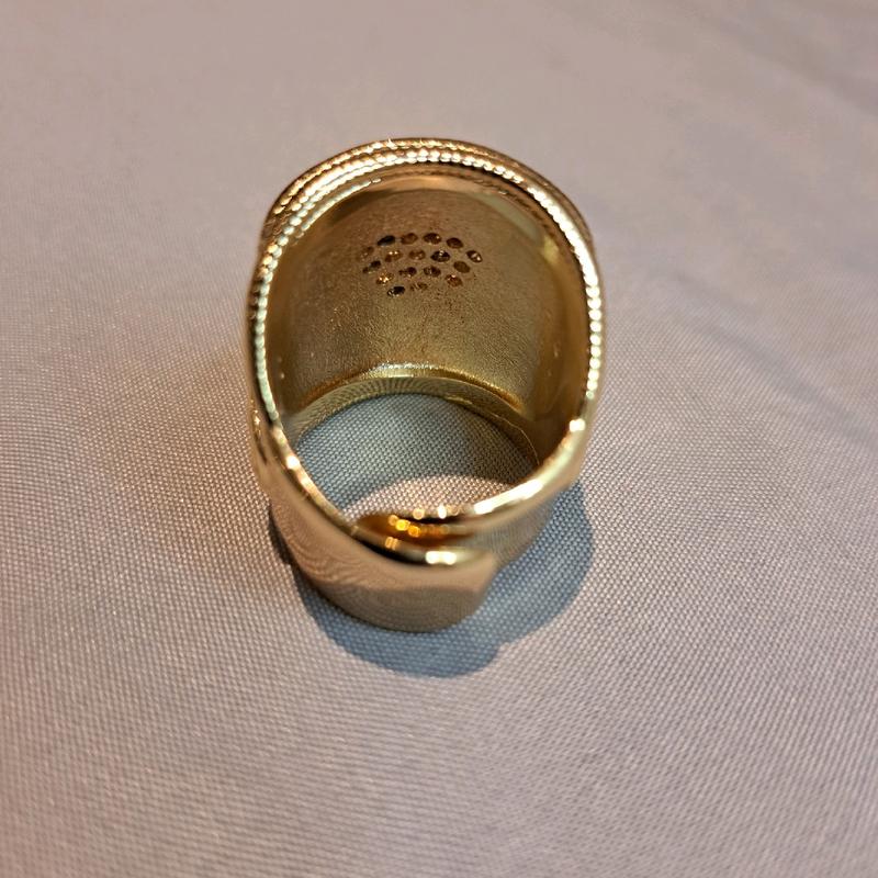 large saddle ring adjustable for size. gold plated stainless Steel. 5