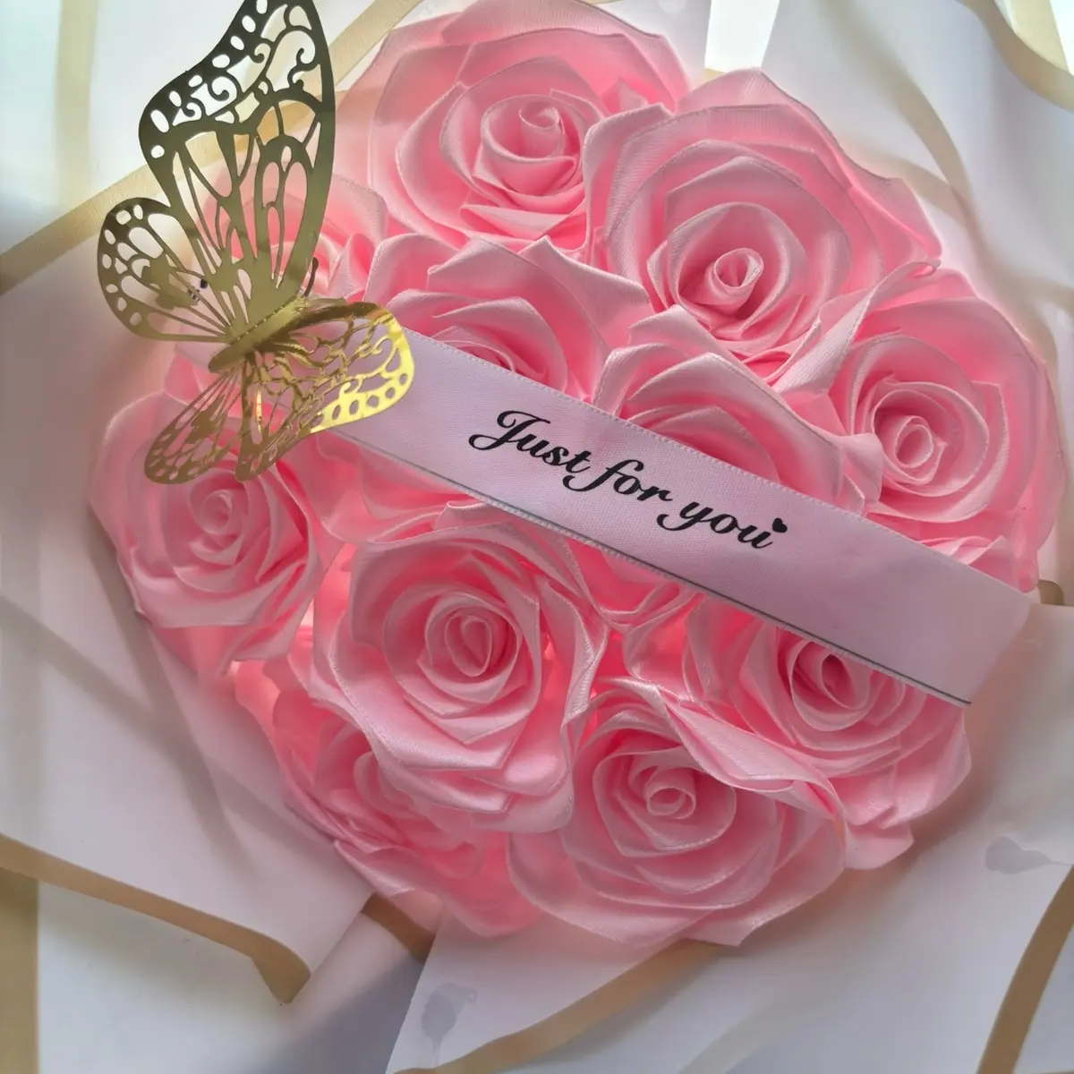 11 pink eternal rose bouquet with white wrapping and a just for you banner and one gold butterfly