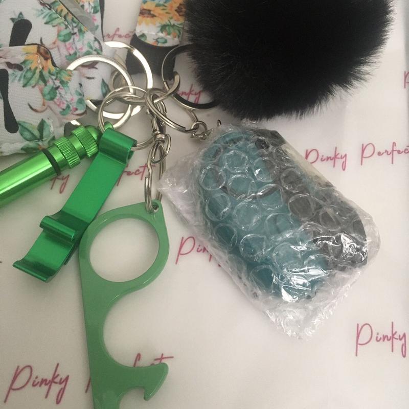 Pinky Perfect UK Legal Green Sunflower Key Chain Set with 3-in-1 Stylus, Door Opener, Bottle Opener, Whistle, Personal Alarm, Light, Wristlet, Sanitiser Pouch, Bottle, Lip Balm Holder, Pom Pom and Car Escape Tool 4