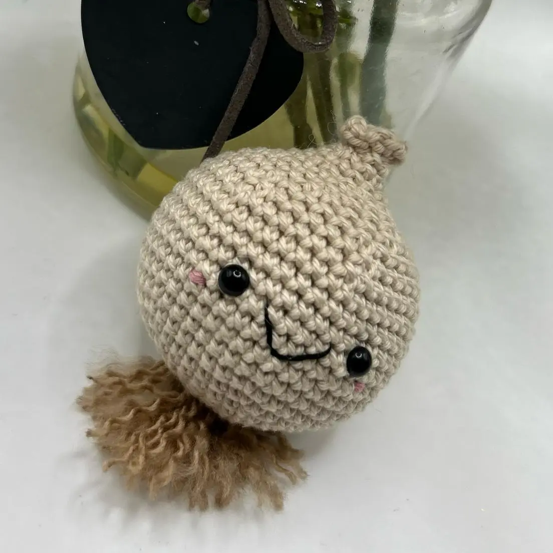 Crochet amigurumi onion with safety eyes and organza gift bag