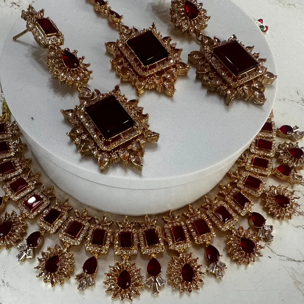 Gold plated stunning ruby and champagne coloured stone work necklace set with beautiful detailed long drop earrings and tikka