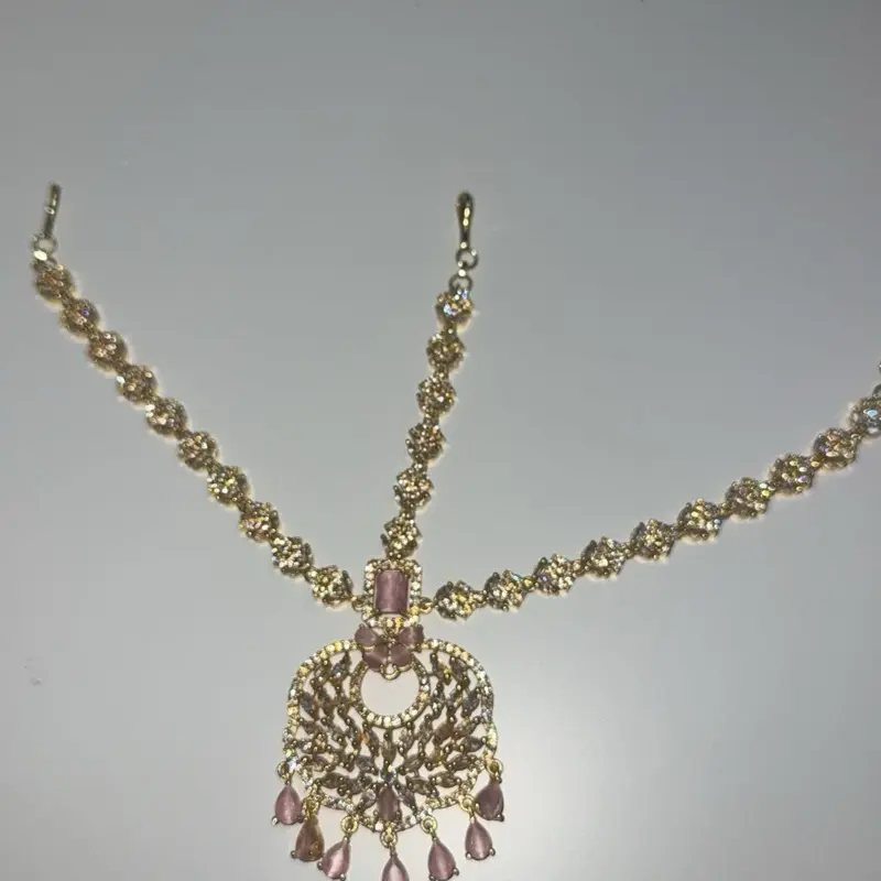 Gold and pink matta patti (headpiece)
